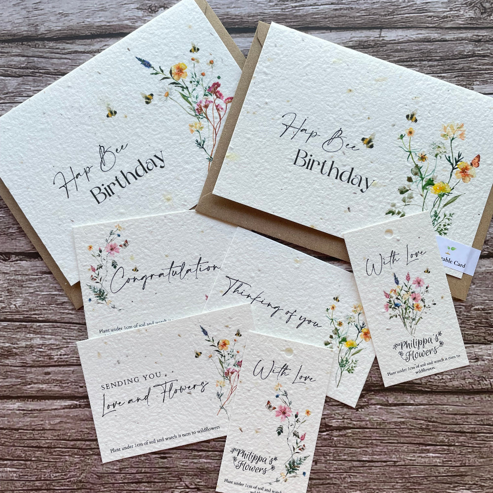 Set of plantable greeting cards, tags and message cards for florists with floral designs and text on a wooden surface