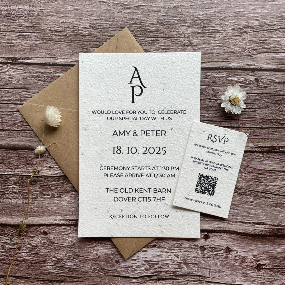 A personalised plantable wedding invitation with a plain monogram design on a wooden surface