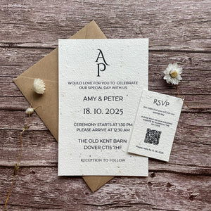 A personalised plantable wedding invitation with a plain monogram design on a wooden surface