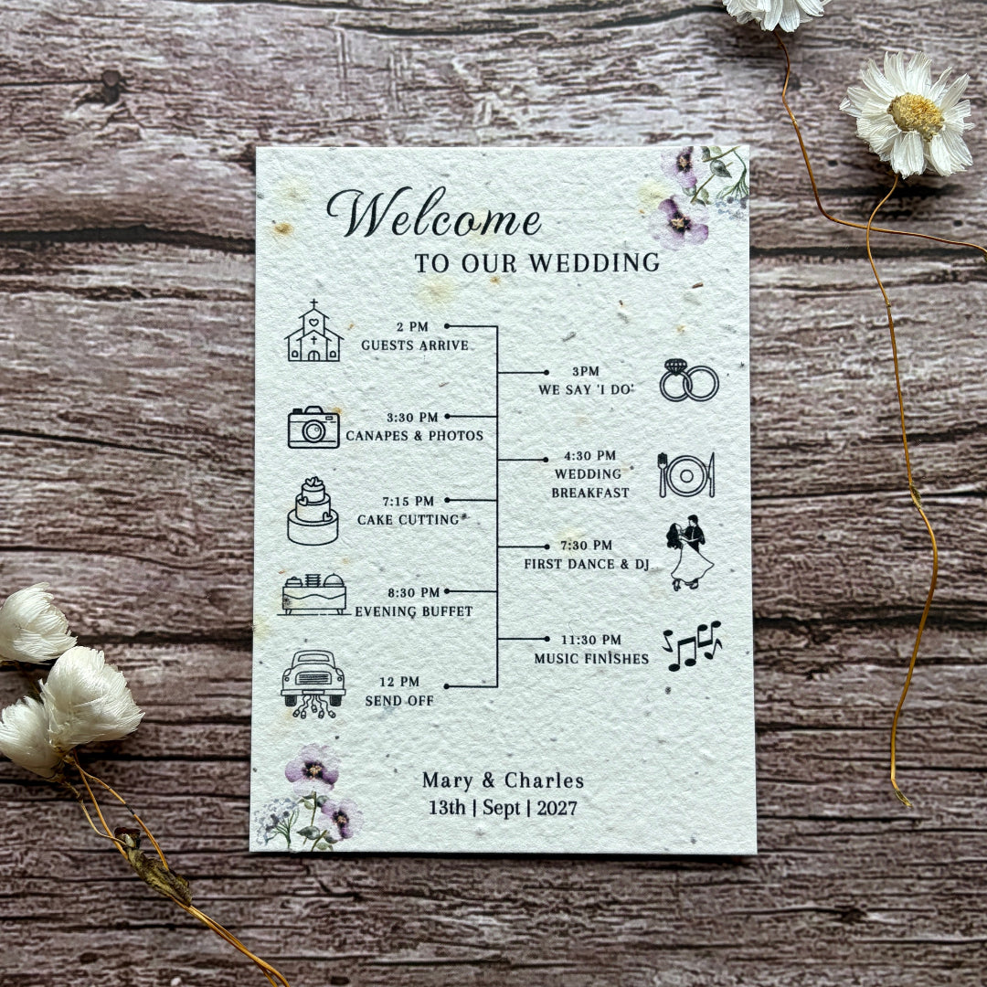 seed paper wedding order of service with lilac flowers on wooden surface