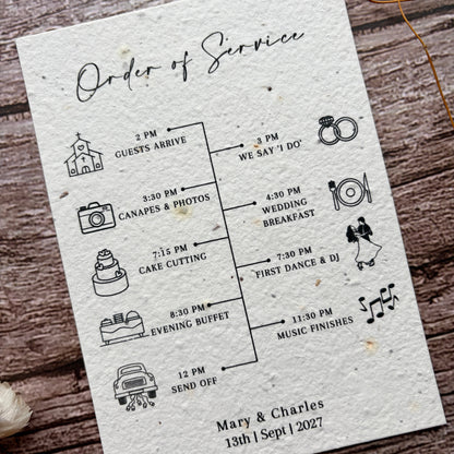 Wedding seed paper order of service card with icons on a wooden surface