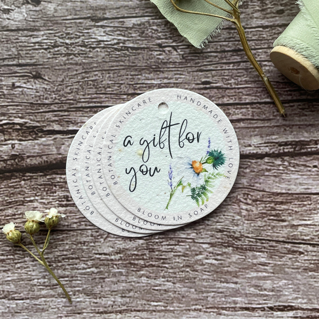 plantable round gift tag on a wooden surface