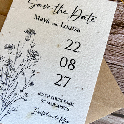 Plantable Save the Date card with floral design and text on a wooden surface