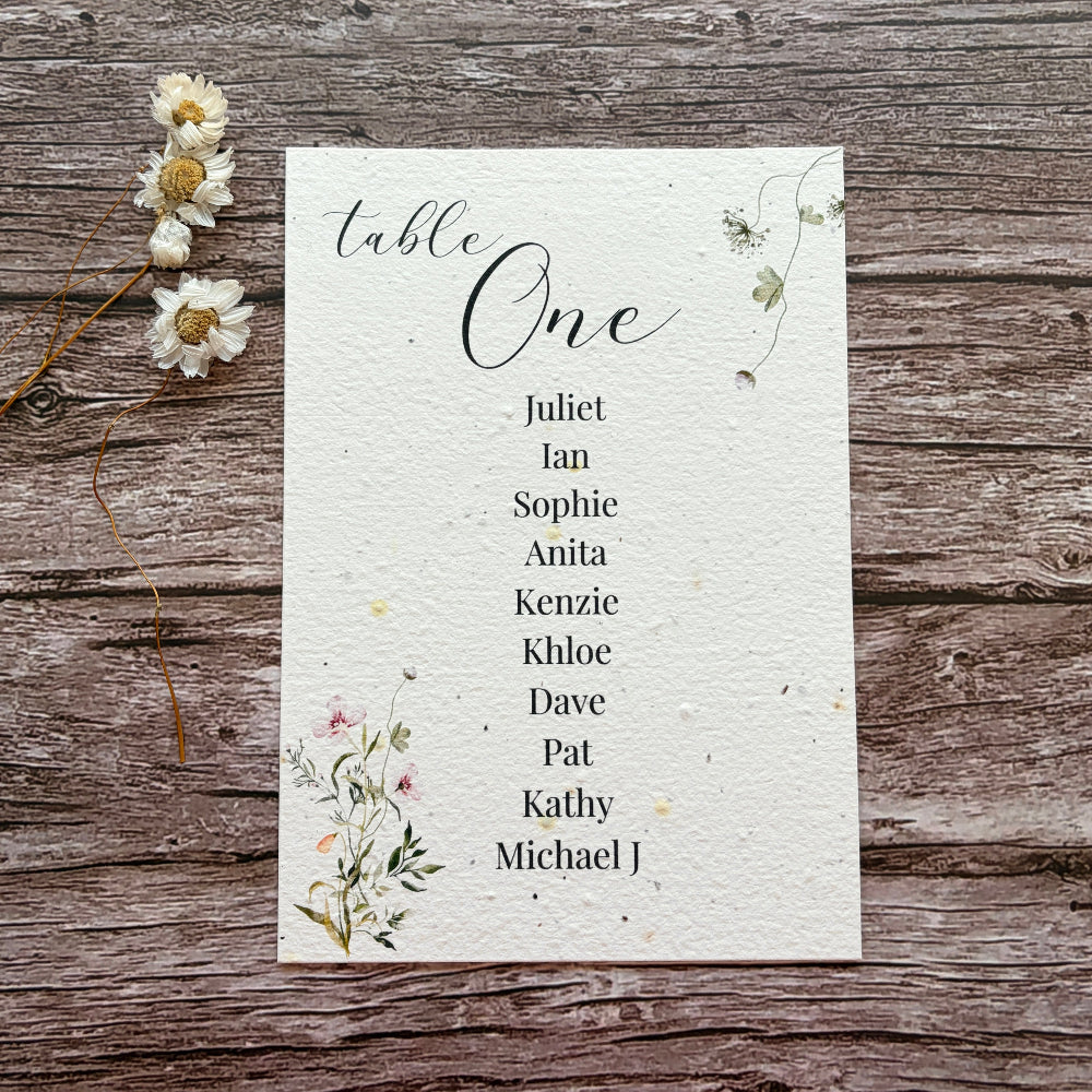 plantable seed paper seating plan cards  on a wooden background