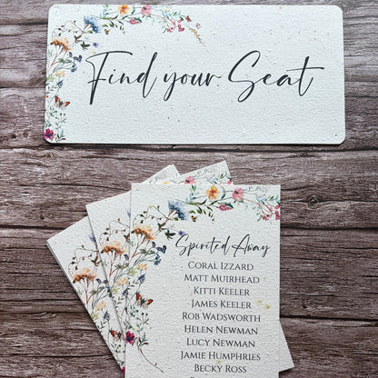 A wedding plantable  seating card set displayed on a rustic wooden background, featuring a large &