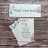 Pink meadow plantable sable seating cards with floral designs on a wooden surface