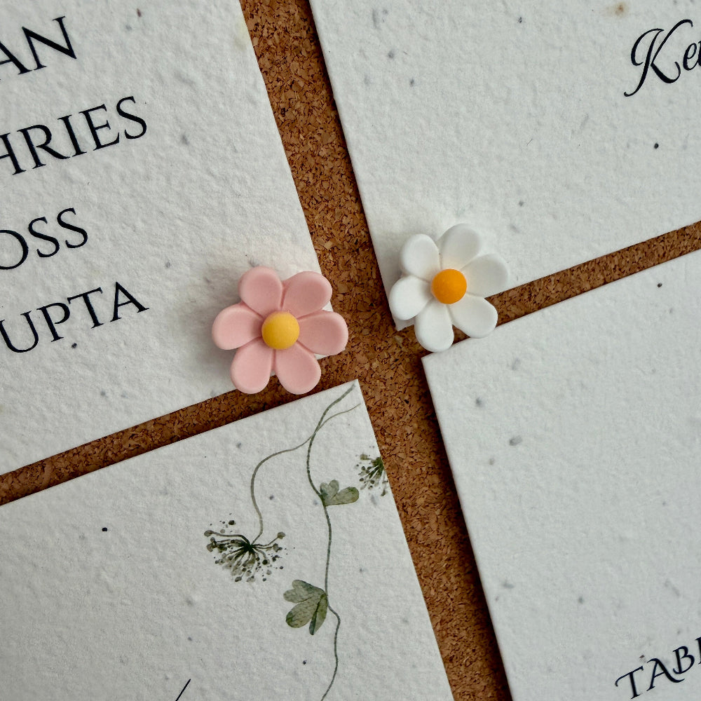 seed paper wedding seating plan on a cork board with flower pins