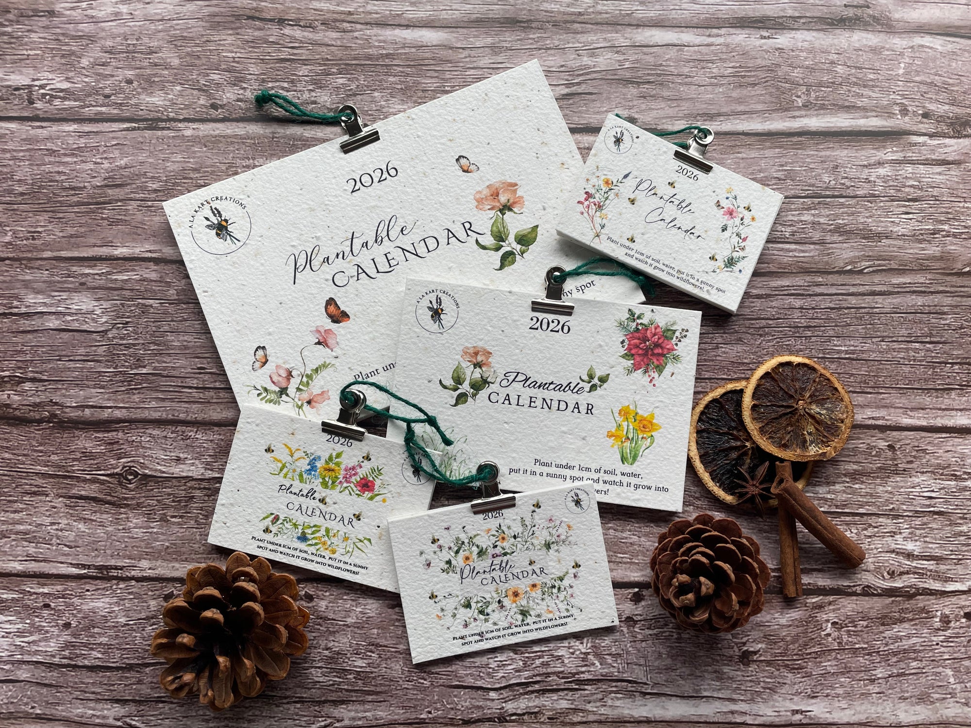 Set of plantable calendar cards on a wooden surface with decorative elements.