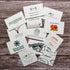 Collection of various plantable business cards on a wooden surface