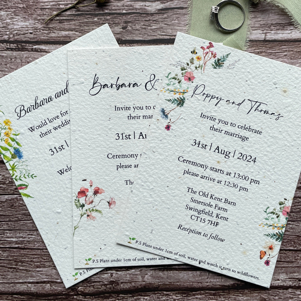 Plantable seed paper wedding invitation card with floral design on a wooden surface