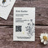 Seed paper business card with QR code on a wooden surface with a cornflower.