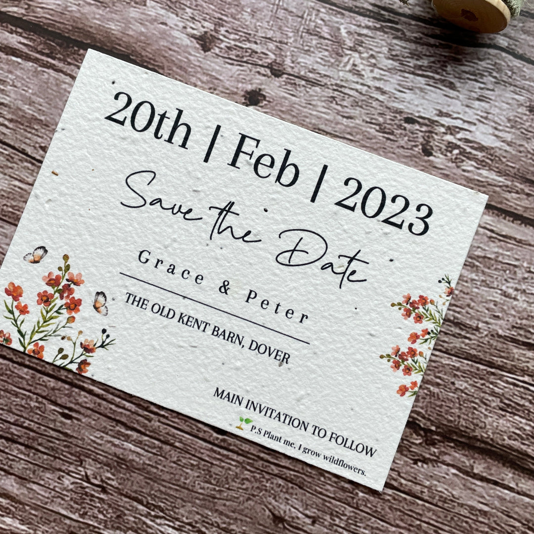 Wedding save the date card on a wooden surface with floral decorations
