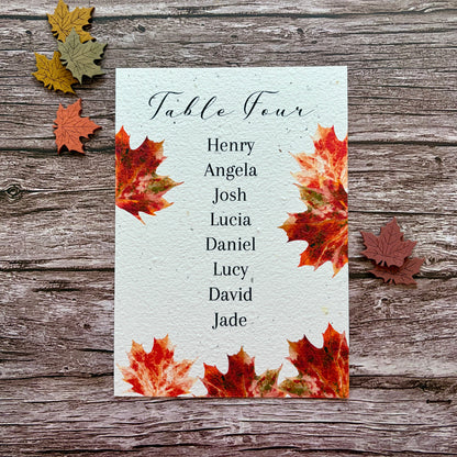 plantable wedding seed paper seating plan cards with maple leaves on a wooden background