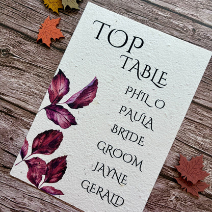 plantable wedding seating plan card with purple leaves on a wooden background