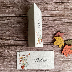 plantable seed paper place cards on wooden board with autumn wildflowers