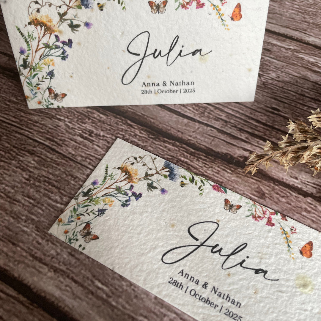 plantable guest place cards on wooden surface with butterfly wildflower design