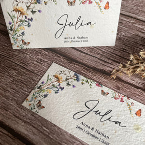 plantable guest place cards on wooden surface with butterfly wildflower design