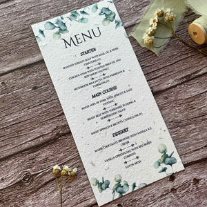 A menu card with a floral design, featuring the word 'Menu' at the top, and a list of items including 'Starter', 'Main Course', and 'Dessert' with decorative elements in the background.