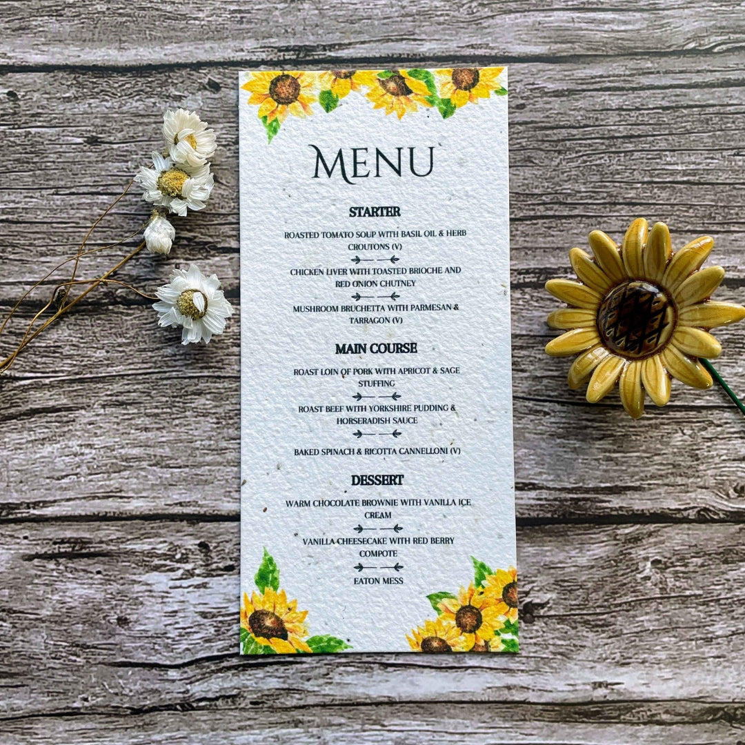 plantable seed paper wedding menu card in sunflower theme, close-up front view, floral design on wooden background, eco-friendly