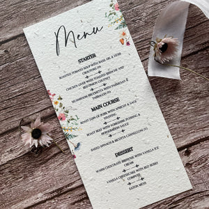 plantable wedding menu cards on wooden surface with wildflower design