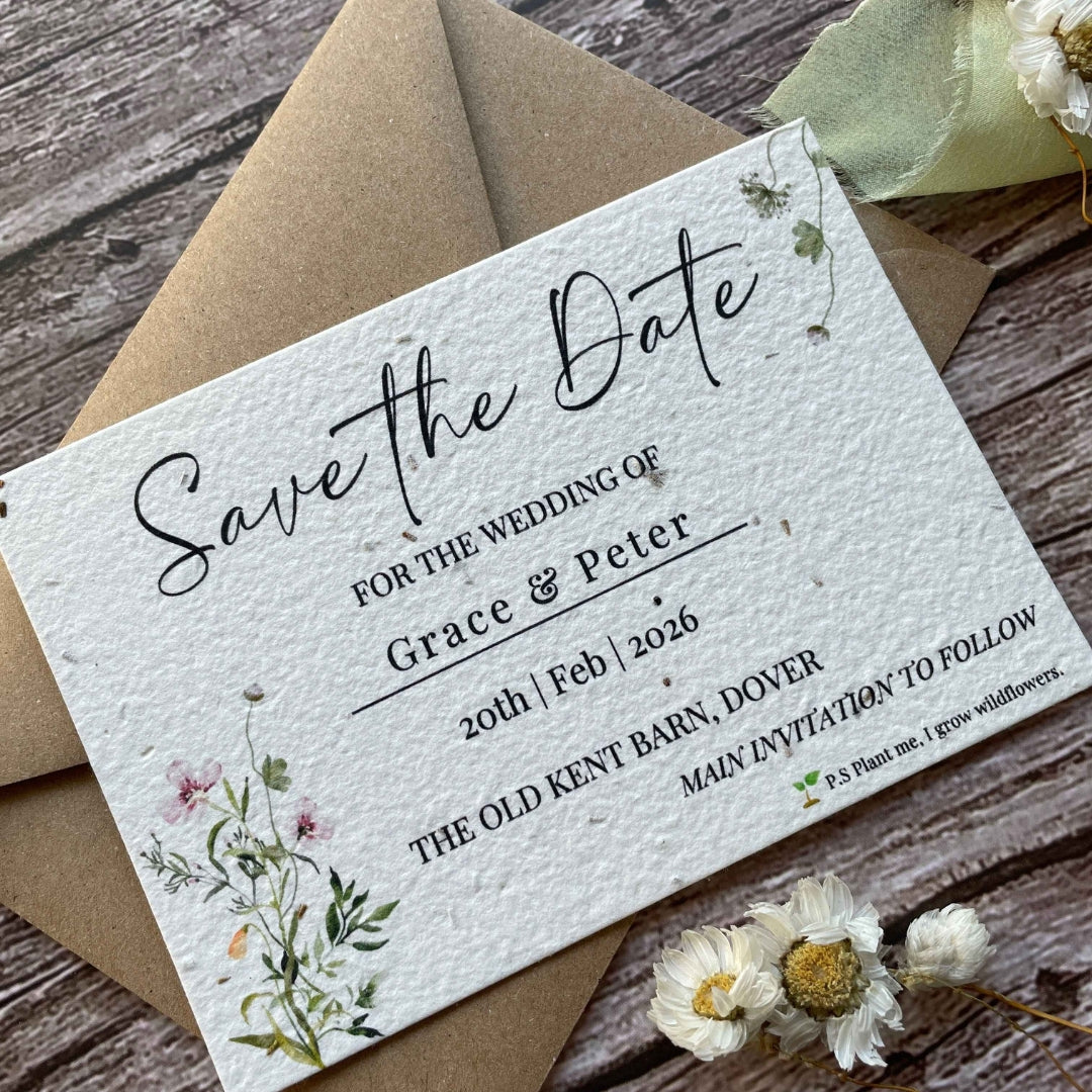 plantable seed paper wedding save the date card in spring green theme with brown kraft envelope, angled left, floral design on wooden background.