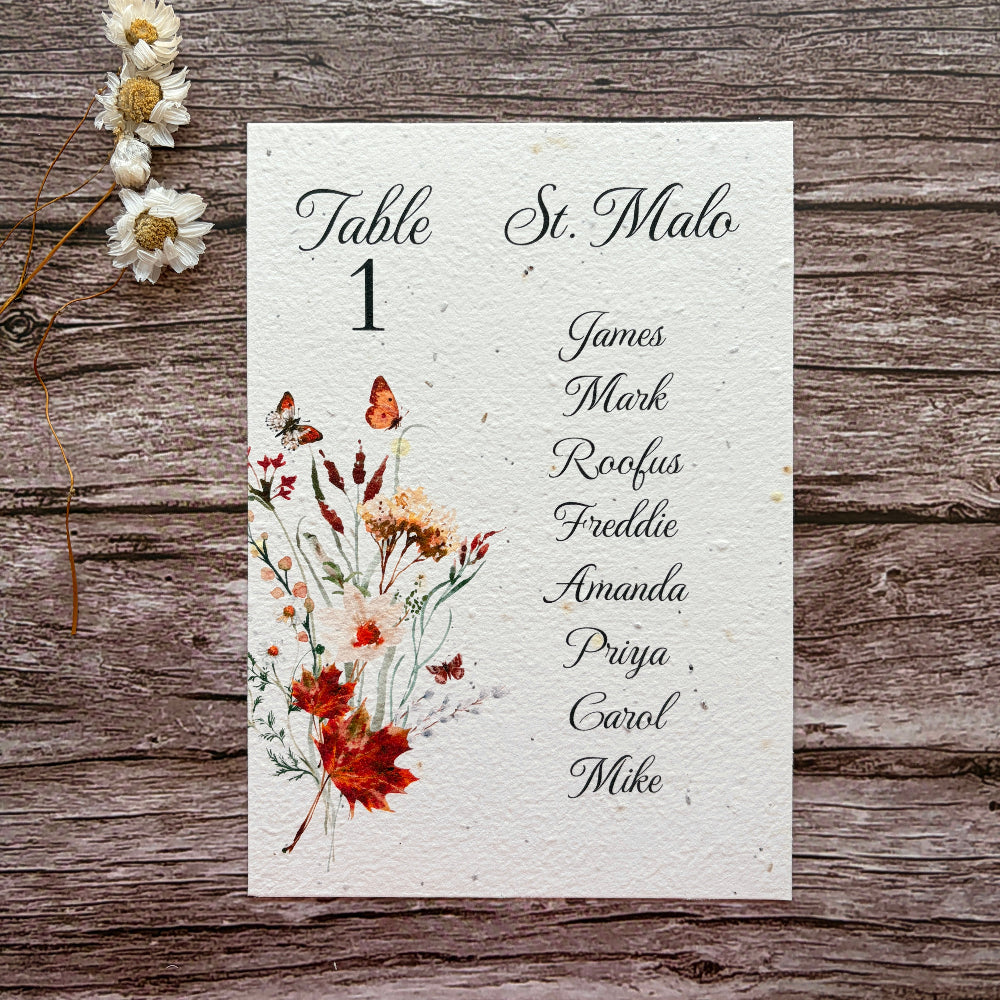 plantable seed paper wedding seating plan with autumn meadow design on a wooden background