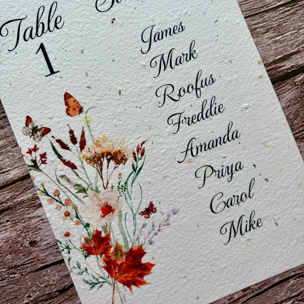 plantable wedding seating plan with autumn meadow design on a wooden background