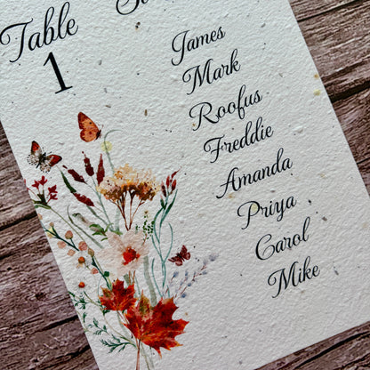 plantable wedding seating plan with autumn meadow design on a wooden background