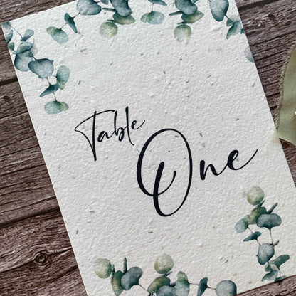 plantable seed paper wedding table number or name cards with eucalyptus theme, angled view, eco-friendly wedding stationery, alakartcreations