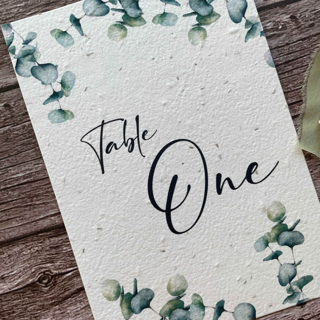 plantable seed paper wedding table number or name cards with eucalyptus theme, angled view, eco-friendly wedding stationery, alakartcreations