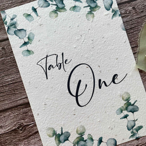 plantable seed paper wedding table number or name cards with eucalyptus theme, angled view, eco-friendly wedding stationery, alakartcreations