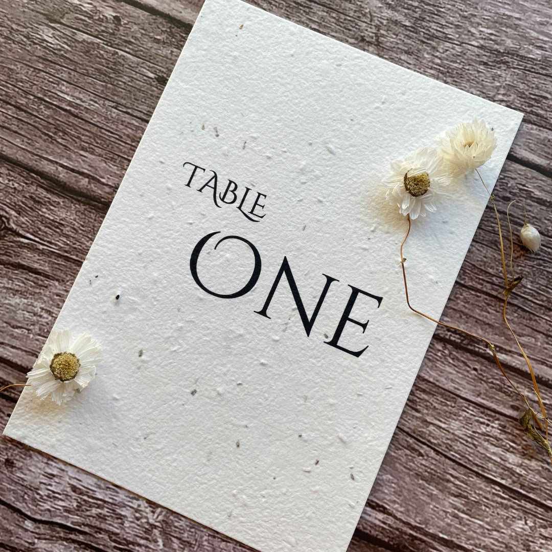 plantable seed paper wedding table number or name cards with minimalistic theme, angled view, eco-friendly wedding stationery, alakartcreations
