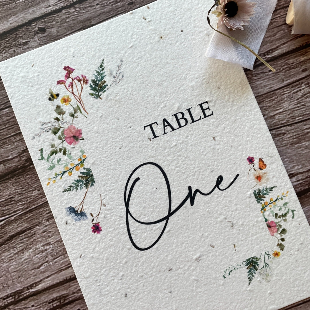 plantable seed paper wedding table number or name cards with wildflower meadow theme, angled view, eco-friendly wedding stationery, alakartcreations