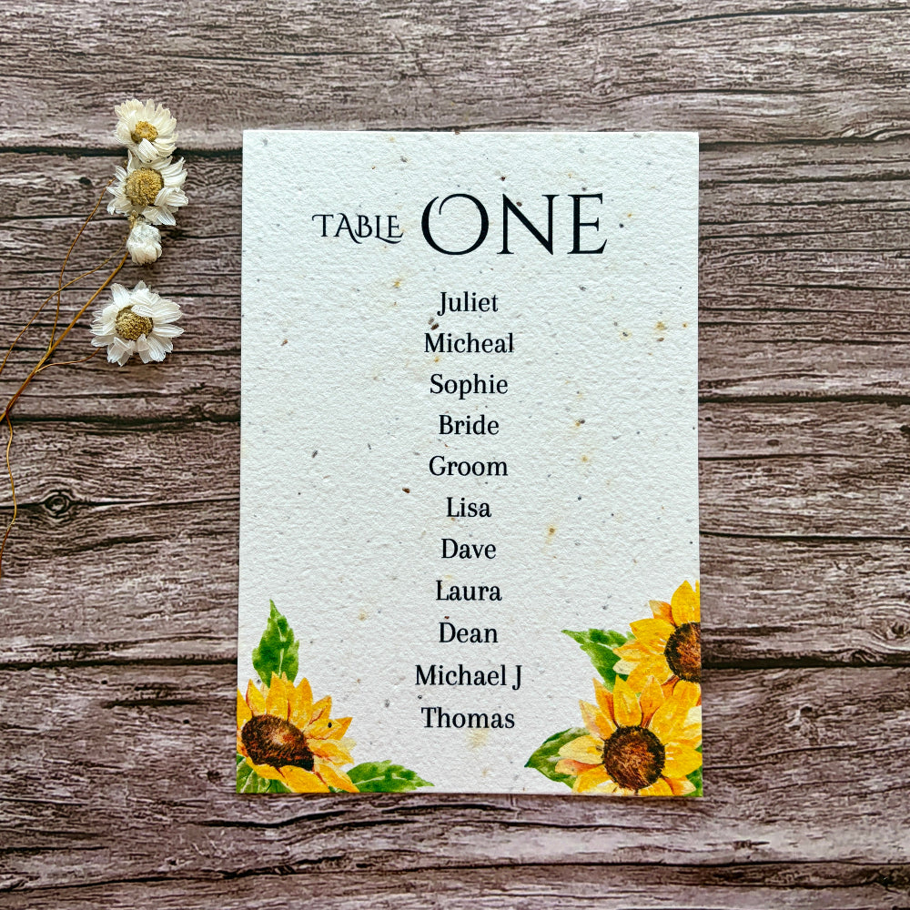 plantable seating plan with sunflowers design on a wooden background