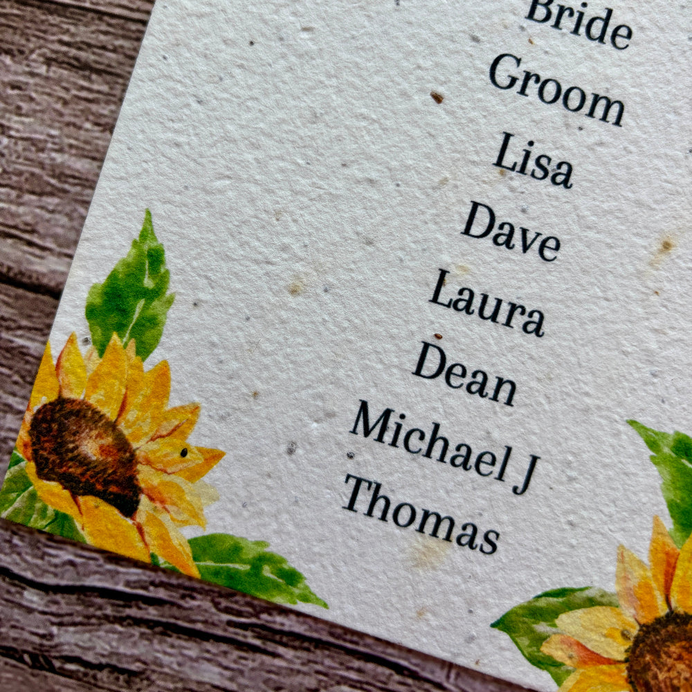 seed paper wedding seating plan with sunflowers design on a wooden block