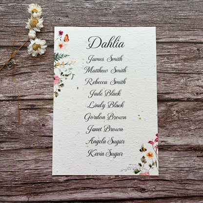 plantable seating plan with wildflower design on a wooden background
