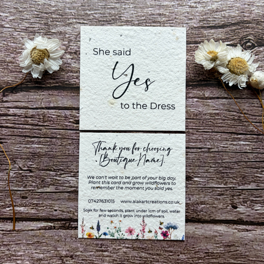 plantable saying yes to dress card with wildflower meadow design on a wooden background
