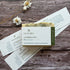 Bar of soap with a plantable label on a wooden surface with dried flowers