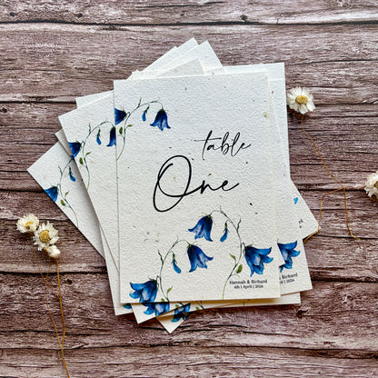 plantable wedding table names or number bluebells design on wooden background