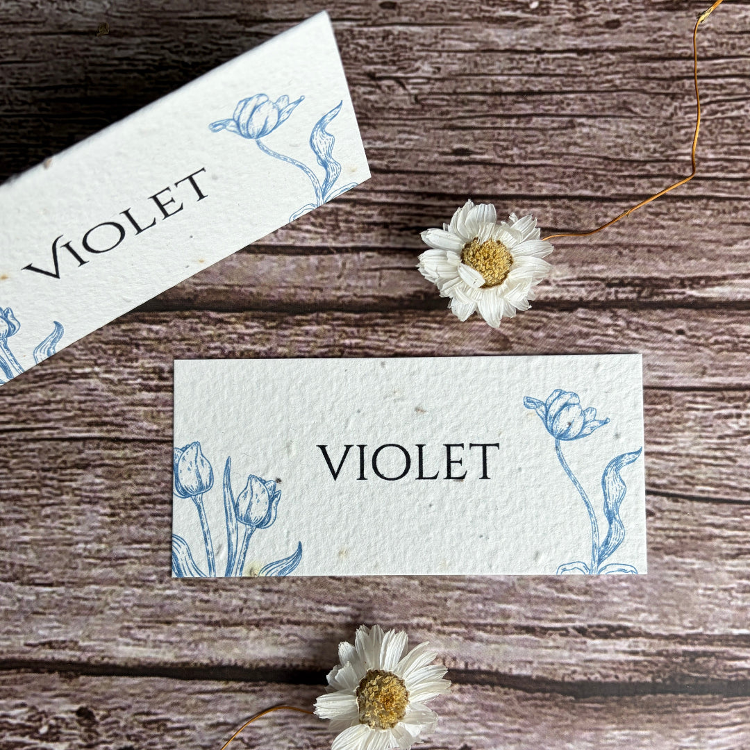 plantable tulip place cards made from seed paper on a wooden surface