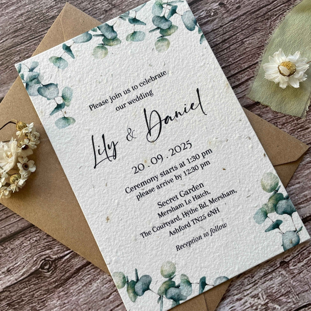 plantable main wedding invites with eucalyptus design on a wooden background