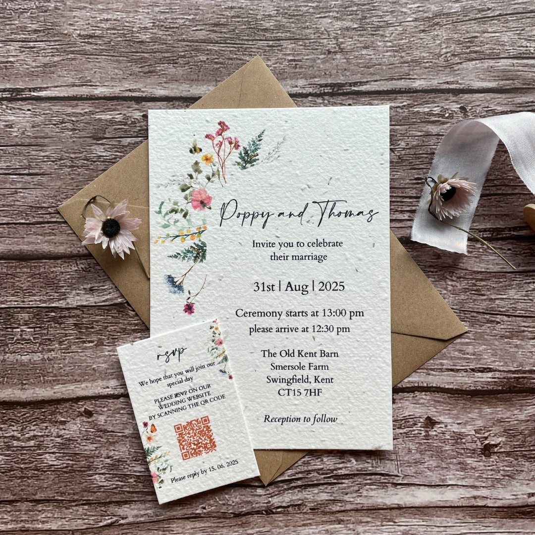 seed paper main invites with wildflower meadow design on a wooden surface