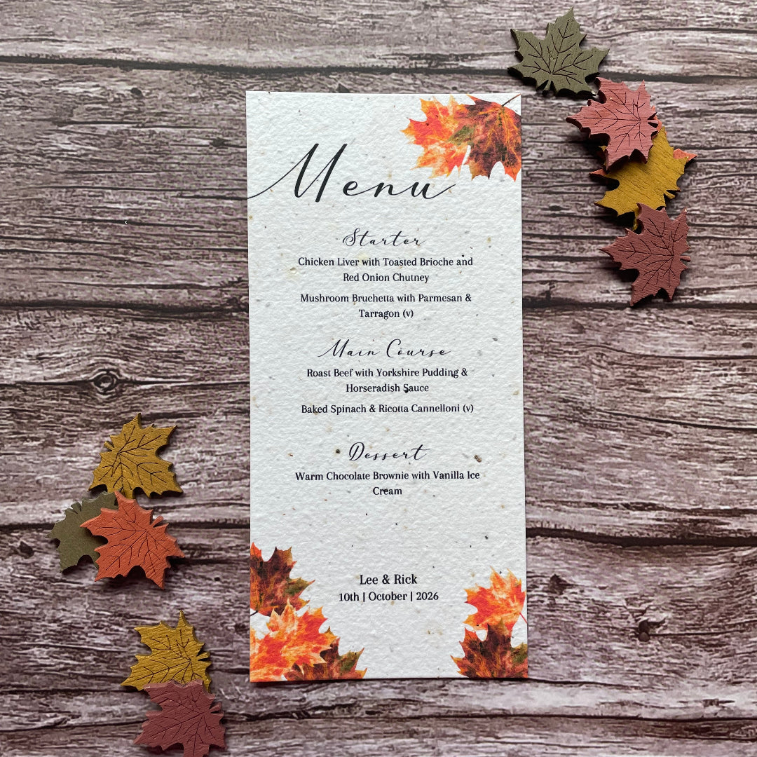 Plantable Menu card with autumn leaf design on a wooden surface