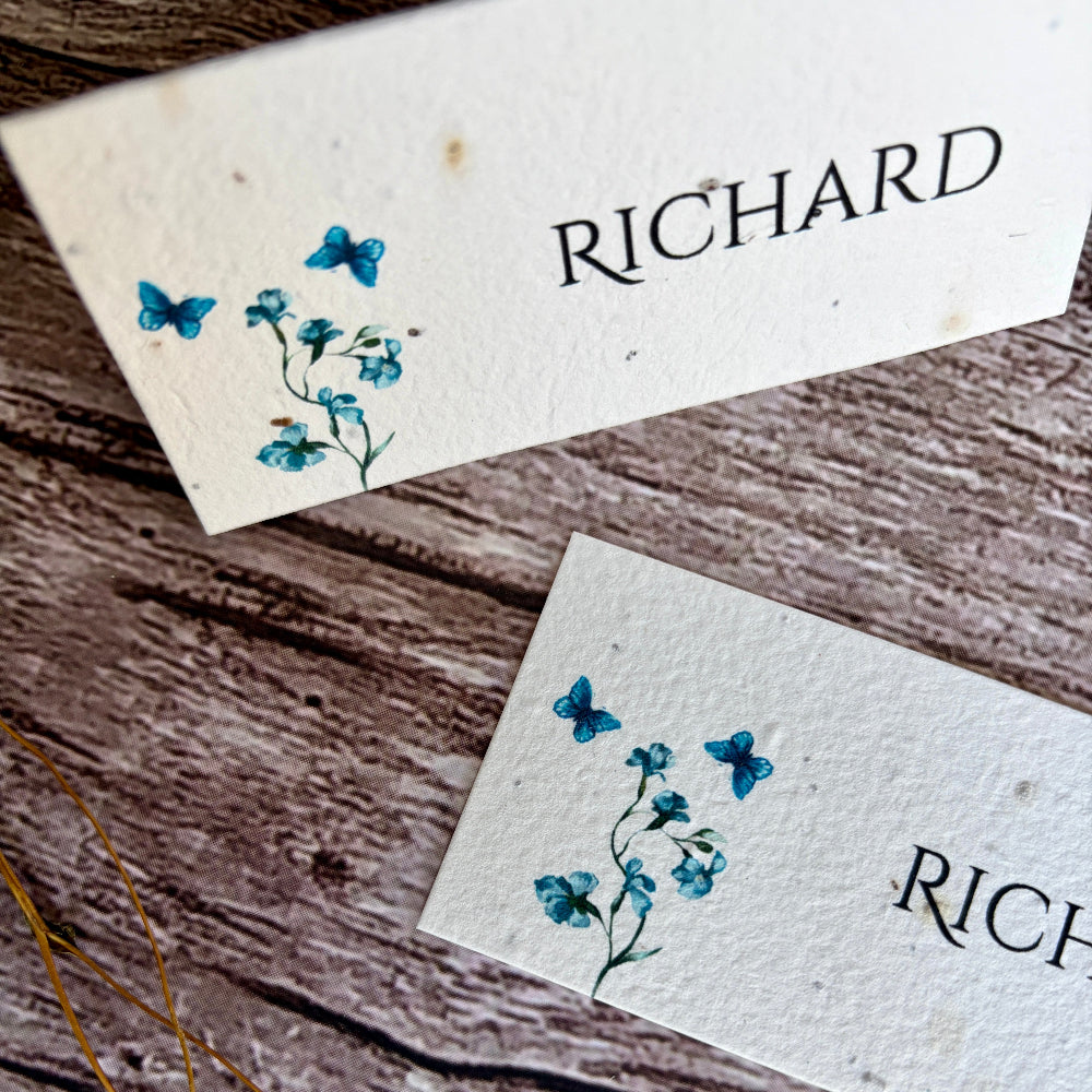 Two plantable wedding name cards with blue sweet peas design and &