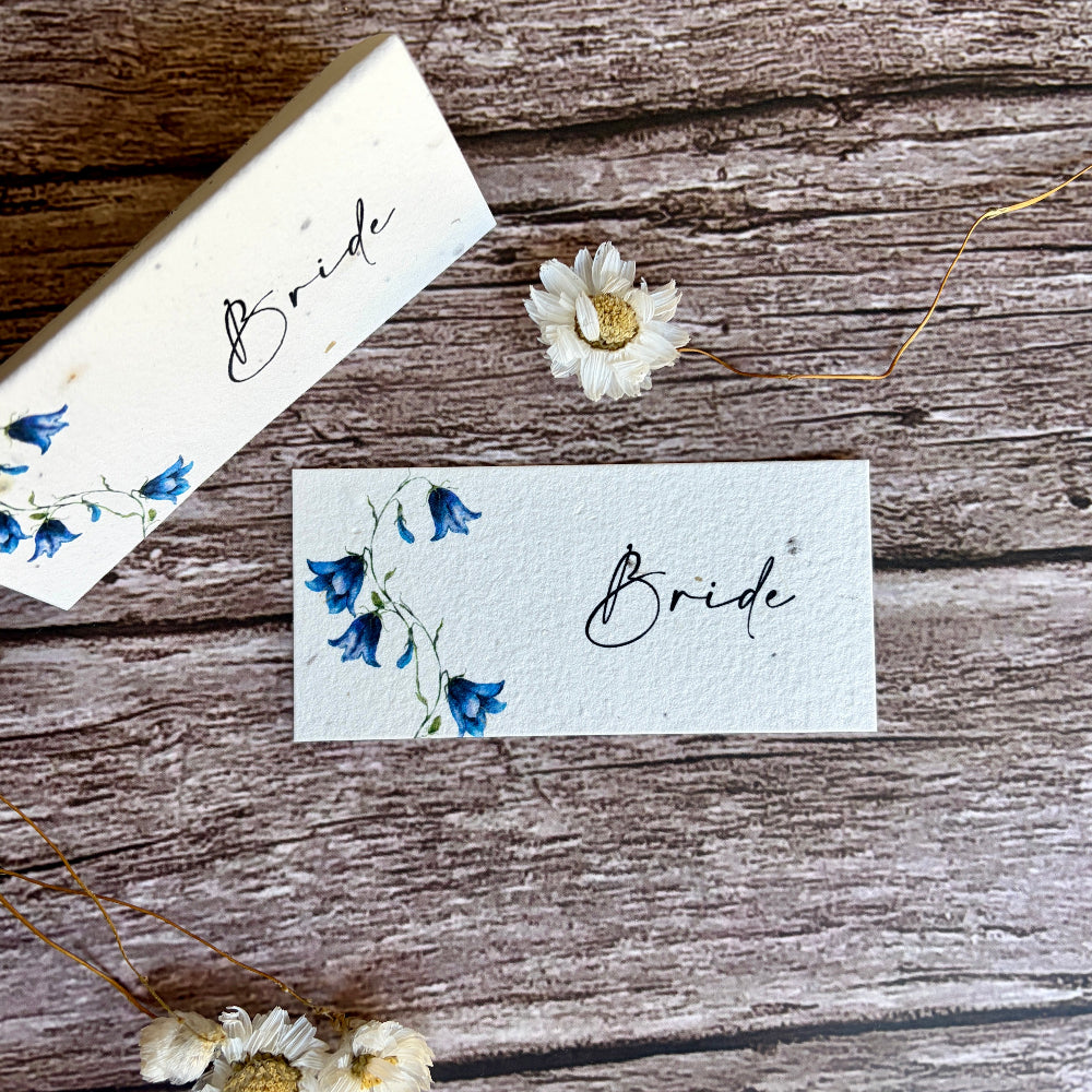 Two sees paper place cards with bluebells designs and &