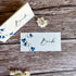 Two sees paper place cards with bluebells designs and &