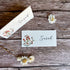Two plantable name cards with floral designs and &