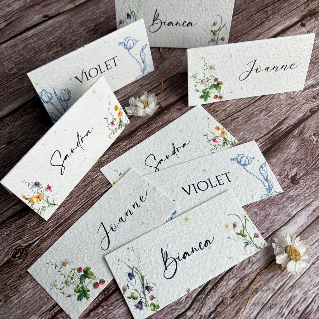plantable wedding place cards with spring flowers on a wooden surface