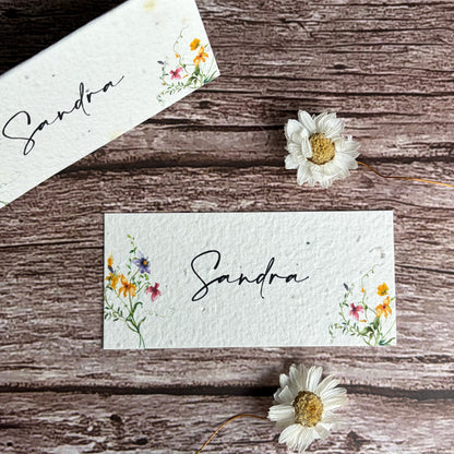 plantable wedding place cards with spring wildflowers on wooden surface