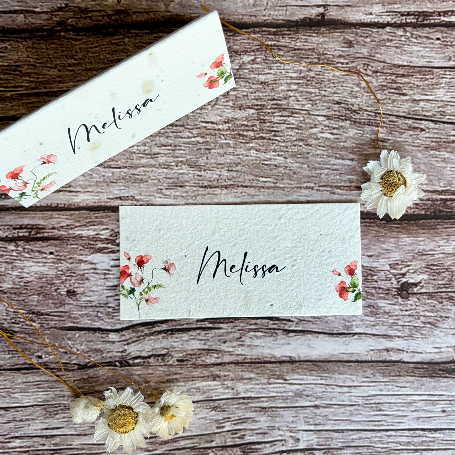 Two plantable place cards with sweet pea designs and &